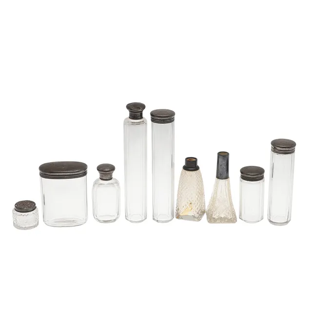 9 SILVER MOUNTED GLASS TOILET JARS AND BOTTLES.