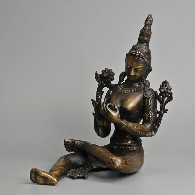 A BRASS BUDDHIST FIGURE OF GREEN TARA, TIBETAN OR NEPALESE, 20TH CENTURY.