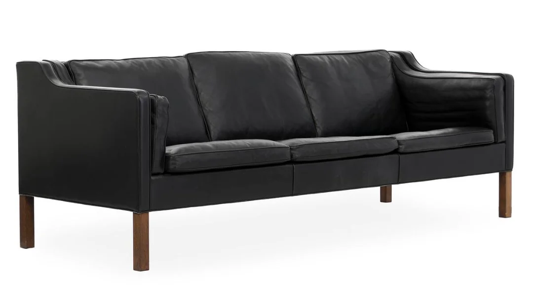 Freestanding three-seater sofa with dark-stained oak legs. Seat, sides and back upholstered in black leather. Model 2213. Designed in 1963. Manufactured by Fredericia Stolefabrik. L. 221 cm. — Modern Furniture — Bruun Rasmussen