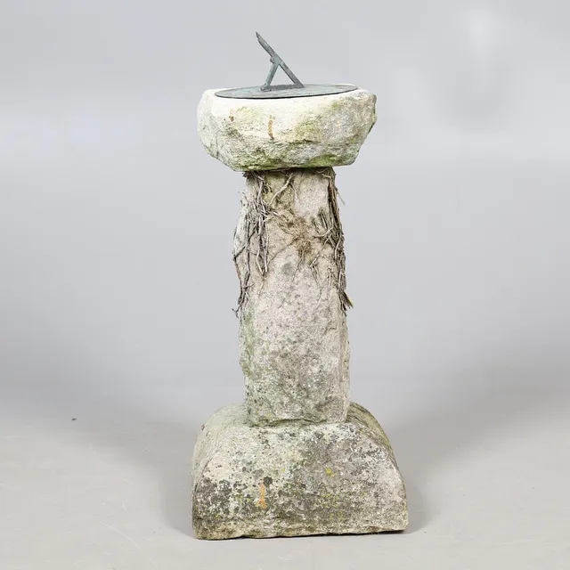 A THREE PIECE CARVED SUN DIAL.