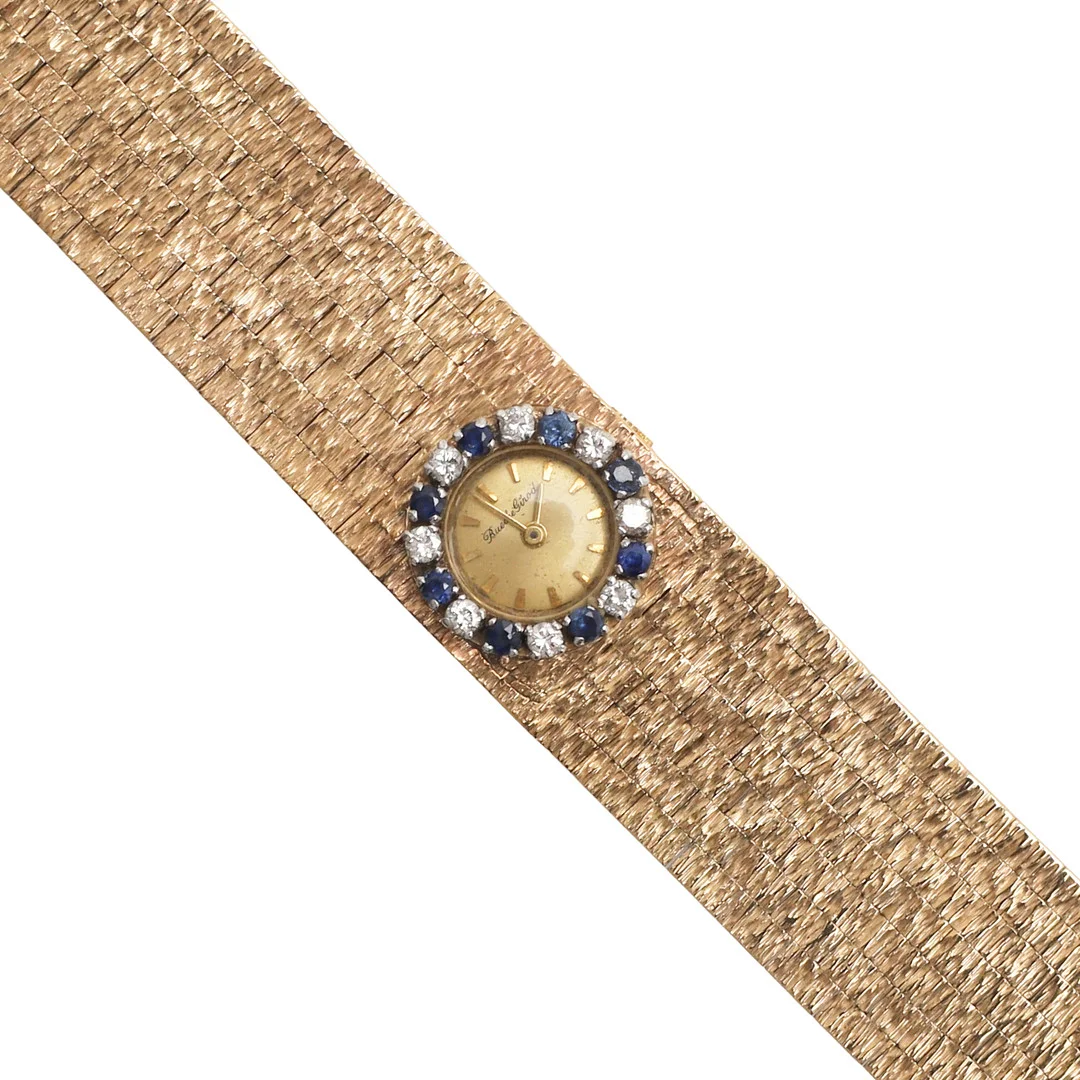 A LADY'S SAPPHIRE, DIAMOND AND 9CT GOLD WRISTWATCHBY BUECHE GIROD. — Wristwatches — Lawrences Auctioneers