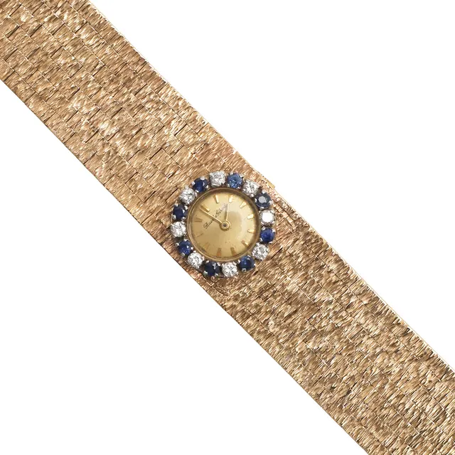 A LADY'S SAPPHIRE, DIAMOND AND 9CT GOLD WRISTWATCHBY BUECHE GIROD.