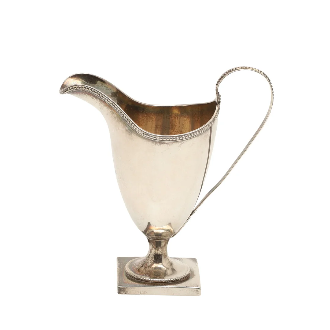 A GEORGE III SILVER HELMET SHAPED CREAM JUG. — Silver — Lawrences Auctioneers