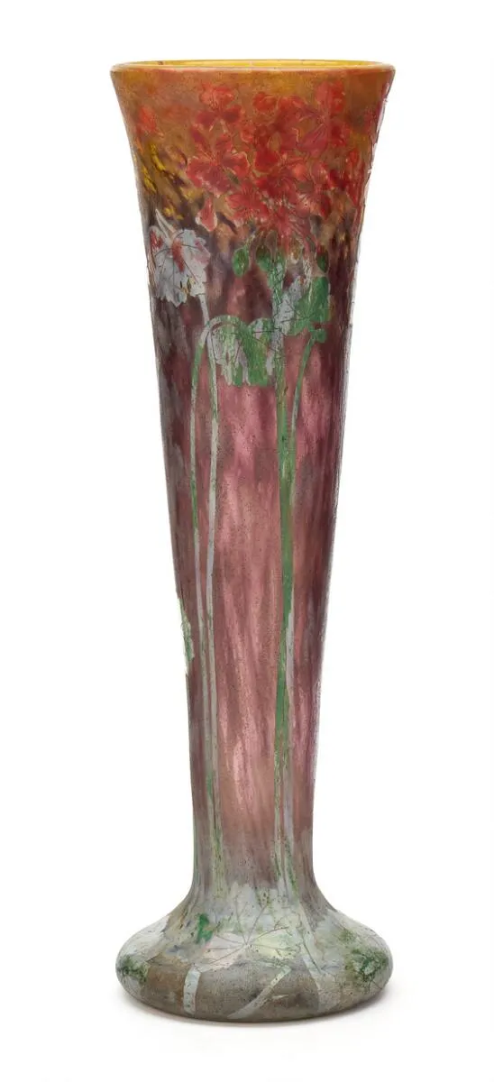 Tall vase of clear, red-purple and yellow glass with overlay of blue, green and red glass cut with flowers and leaves. Signed Daum Nancy. H. 50 cm. Diam. 15 cm.