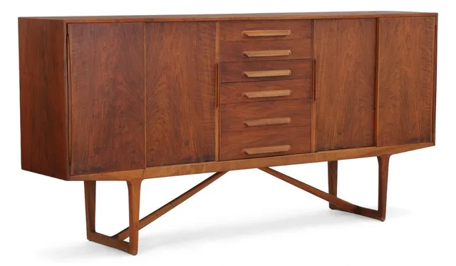 Sideboard of walnut wood. Front with six drawers and four sliding doors behind which shelves and drawers. Manufactured by Brande Møbelfabrik. H. 110 cm. W. 225 cm. D. 45 cm.