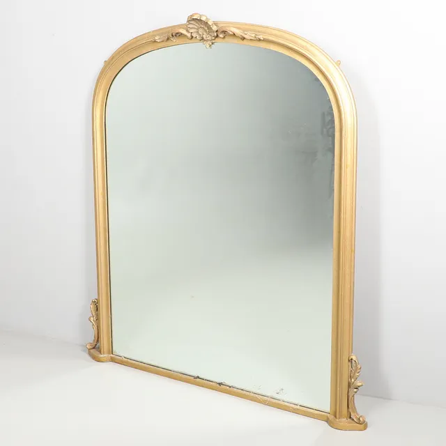 A GILT OVER MANTEL MIRROR.