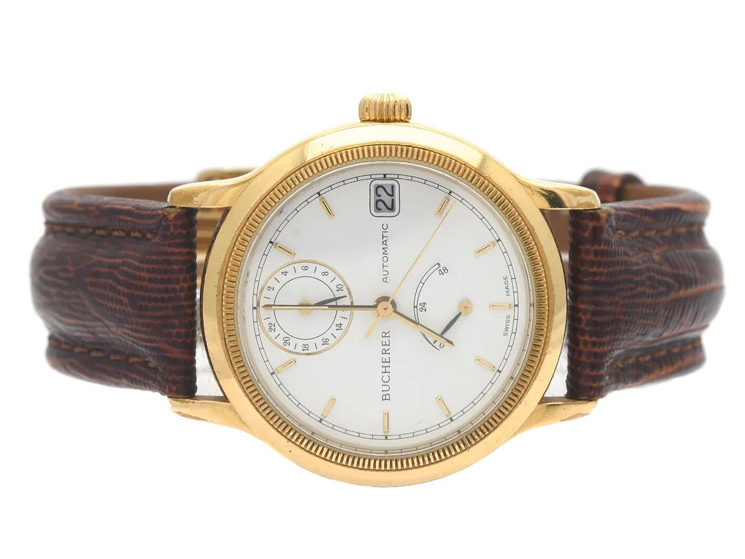 BUCHERER, herrur, 34,5 mm, Cal ETA 2892-2, Boett nr. 2892.9035.501, doublé (10 micron), automatisk, safirglas, datum, 24-timmarsvisning, gångreservsindikator, renoverad urtavla, skadad urtavla, skadad boett, glasbaksida, läderband, viklås (ej original), ca 1995. — Klockor/Bucherer — Kaplans