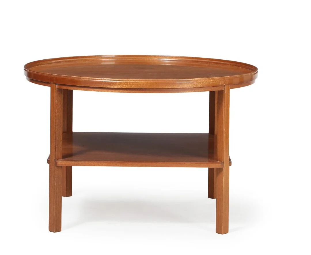 Circular mahogany coffee table with slightly raised edge and underlaying shelf. Model 6687. Designed 1929. Made and marked by Rud. Rasmussen Cabinetmakers. H. 52. Diam. 80 cm. — Modern Furniture — Bruun Rasmussen