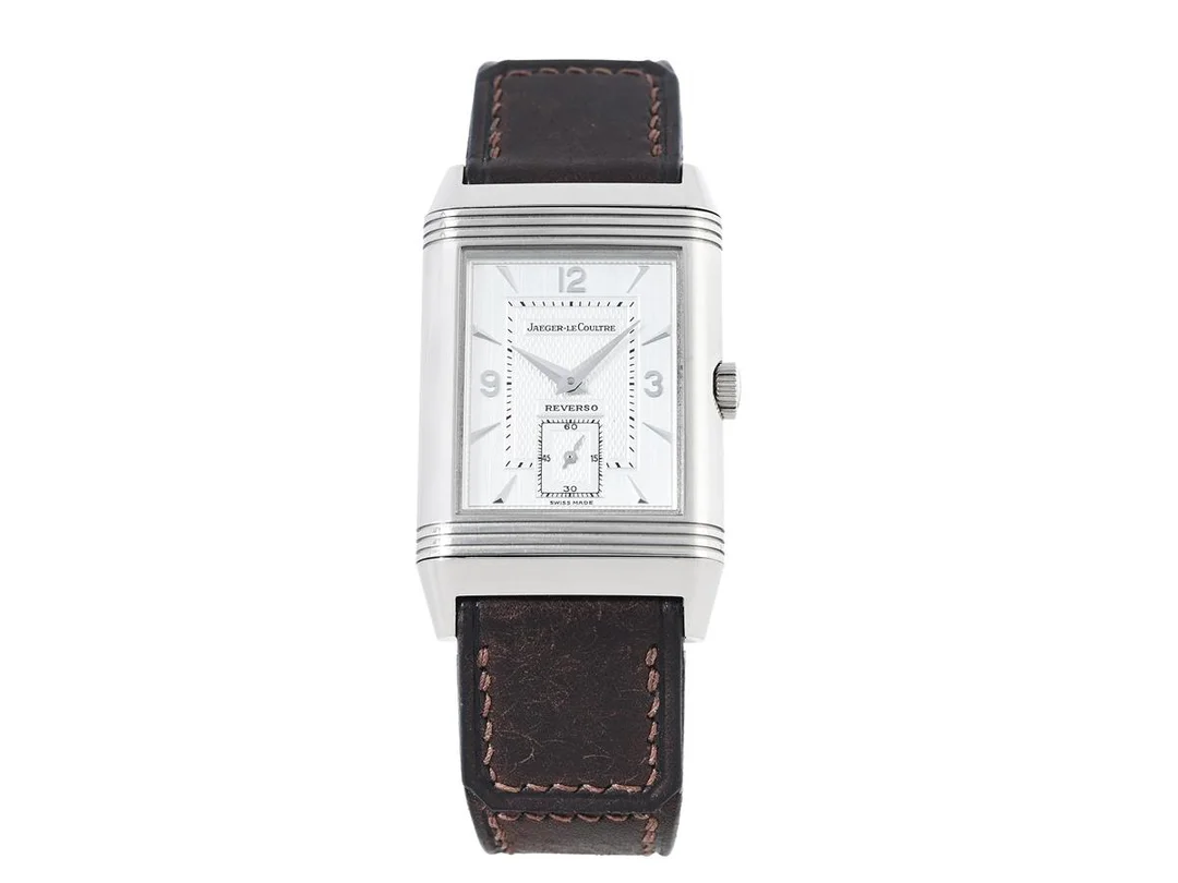 JAEGER-LE COULTRE, Reverso, "Geneva Fountain", Cal 822, Serie nr. 1807477, Ref nr. 275.342.626, Boett nr. 270.3.62, herrur, 26 x 36,5 (42,3) mm, 18K vitguld, manuell, safirglas, liten sekundvisare, diamanter på boetten (40 st. ca 0,16 ctv), läderband, originalspänne i 18K vitguld, cert, december 1995, box (skadad), ytterkartong. Limiterad men ej numrerad (1 av 20). — Klockor/Jaeger-Le Coultre — Kaplans