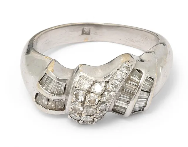 A ring set with numerous brilliant-cut and tapered baguette-cut diamonds, mounted in 14k white gold. Weight app. 6.5 g. W. 9 mm. Size 49.