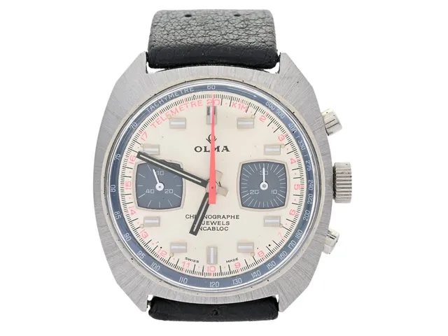 OLMA, kronograf, "Tachymetre/Telemetre", Cal Valjoux 7730, Boett nr. 3878, herrur, 37 mm, stål, manuell, plexiglas, gummiband (Tropic), ca 1975.
