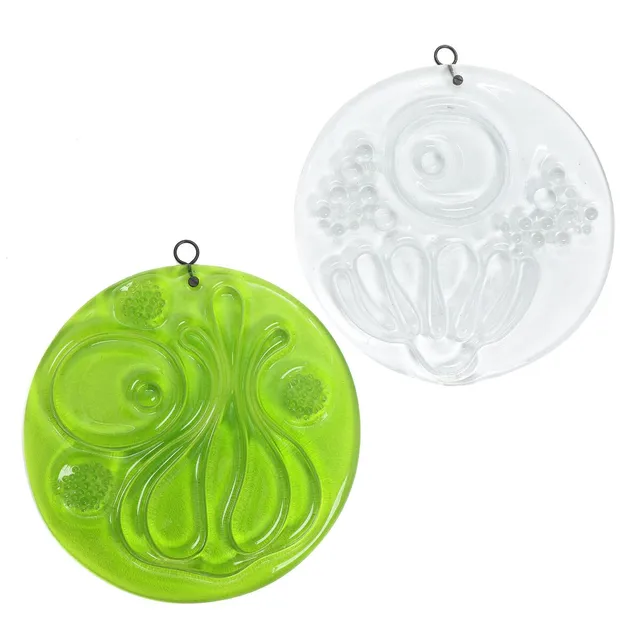 “Spring” and “Winter”. Unsigned. Two clear and green glass reliefs. Manufactured by Holmegaard. Diam. 40 cm. (2)