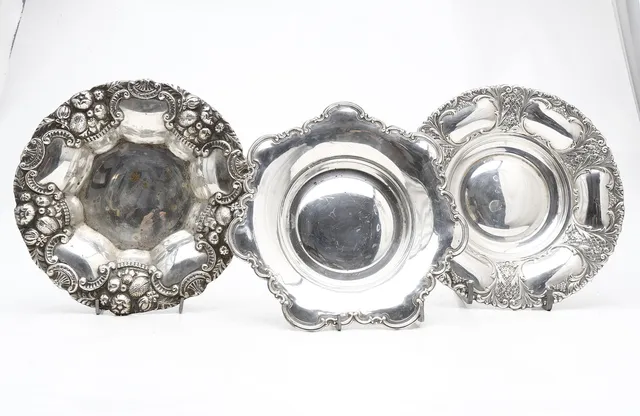 Three centrepieces in silvery metal, 20th Century.
