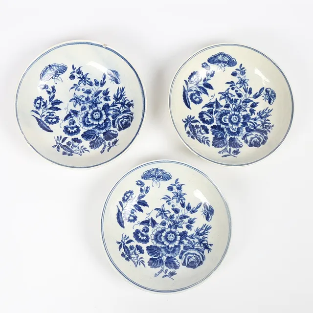 THREE 18TH CENTURY WORCESTER BLUE AND WHITE 'BUTTERFLY' SAUCERS, FIRST PERIOD (3).