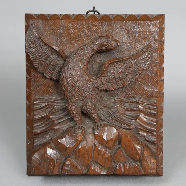 A LATE 19TH CENTURY CARVED WALNUT BLACK FOREST EAGLE PLAQUE.