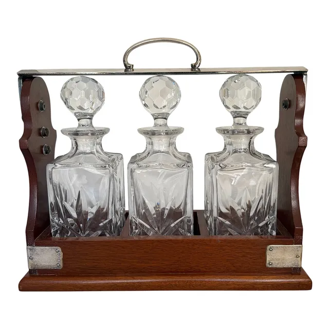 A REPRODUCTION VICTORIAN STYLE THREE BOTTLE TANTALUS.
