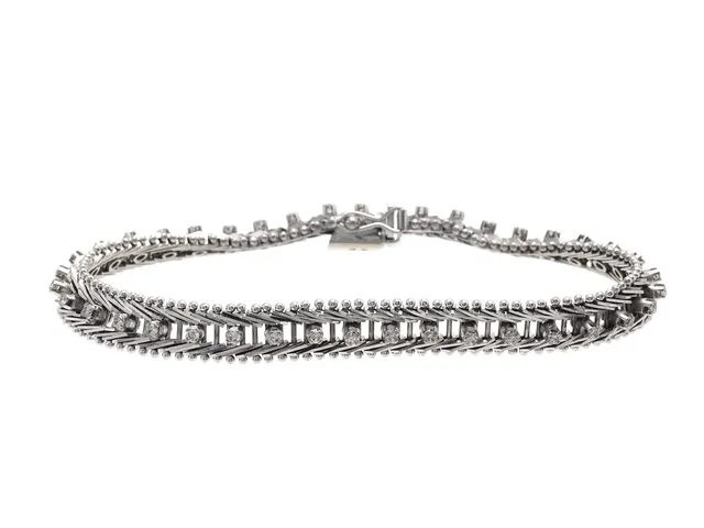 ARMBAND, 18K vitguld, 39 briljantslipade diamanter ca 0,58 ctv ca W/SI, längd 19,5 cm, vikt 22,3 g.