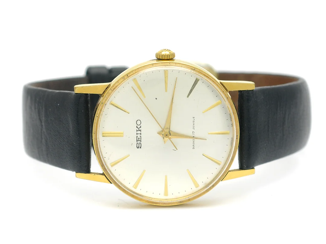 SEIKO, herrur, 32,5 mm, Cak 66A, Ref nr. 66-9990, Boett nr. 7701195, doublé, manuell, plexiglas, skadad urtavla, defekt, läderband, ca 1960. — Klockor/Seiko — Kaplans