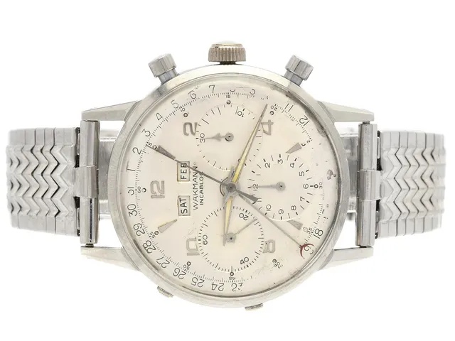 WAKMANN, s.k. "Triple Date", kronograf (ej synkroniserad), Cal Valjoux 72C (WOG), herrur, 38 mm, stål, manuell, plexiglas, dag, datum, månad, renoverad urtavla, skadad urtavla, ca 1959, metallänk ej original (Champion).