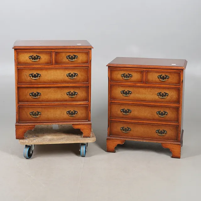 A PAIR OF REPRODUCTION WALNUT CHESTS.