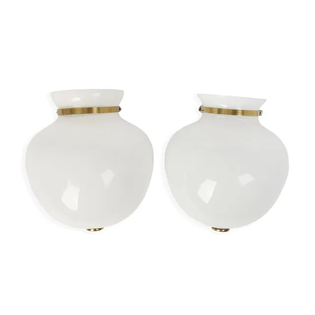 “Half-vase Lamp, model Shell house”. A pair of wall sconces with vase-shaped opal glass shades. Manufactured 1940s by Louis Poulsen. H. 24 cm. W. 22 cm. (2)