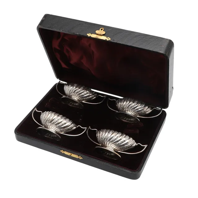 A CASED SET OF FOUR LATE VICTORIAN SILVER SALTS.