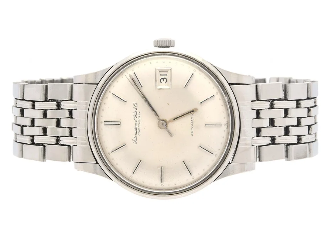 INTERNATIONAL WATCH Co, Schaffhausen, herrur, 34 mm, Cal 8541, Serie nr. 1750723, Boett nr. 1733862 / 809A, stål (Staybrite), automatisk, plexiglas, datum, skadad urtavla, defekt (går ej, servicebehov), originallänk, viklås (Gay Frères), Ref nr. 1.66/IB, ca 1966. — Klockor/IWC — Kaplans