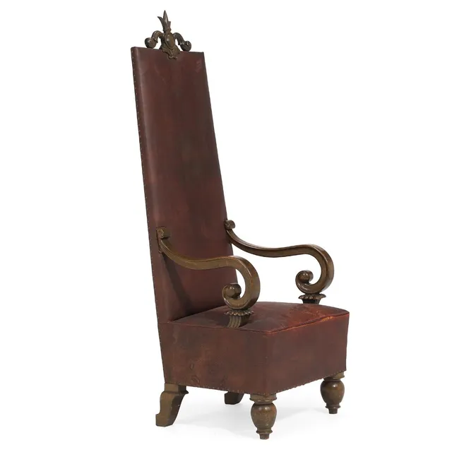 Large high-backed stained oak chair with ornaments. Upholstered with burgundy studded leather. Manufactured by AB Nordiska Kompaniet, 1920s-1930s. H. 178 cm. W. 68 cm. D. 72 cm.