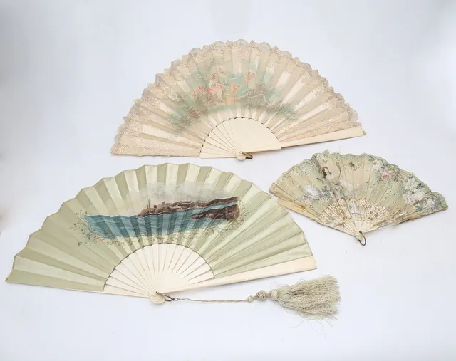 Three fans with painted and lithographed paper leaves, early 20th Century.