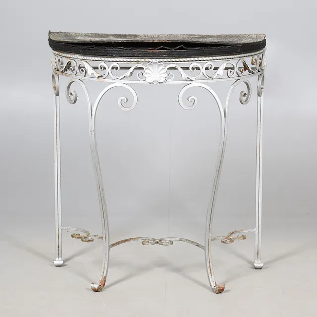 A WROUGHT IRON DEMI-LUNE GARDEN TABLE.