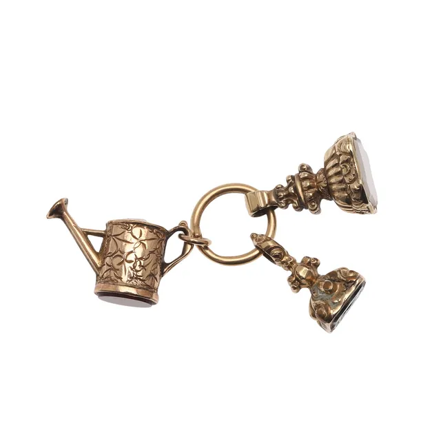 TWO GOLD FOB SEALS AND A GOLD CHARM.