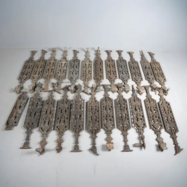 AN EXTENSIVE SET OF VICTORIAN CAST IRON STAIRCASE SPINDLES OR BALUSTERS.