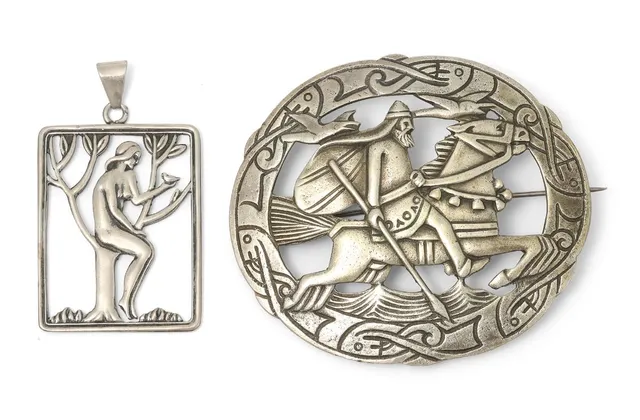Two brooches of sterling silver respectively set with motif in the shape of Eve and Odin. Weight in total app. 38 g. L. incl. eye-let 5.1 cm. App. 5.9×6.8 cm. (2)