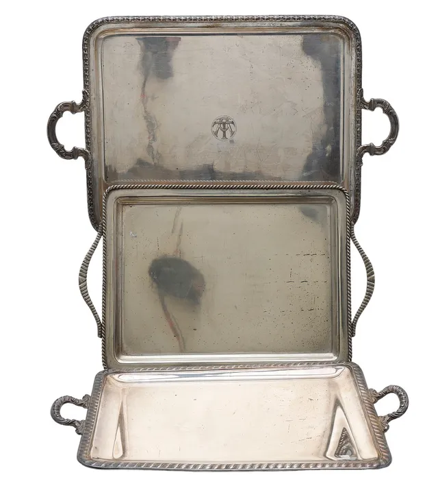 Three silvery metal trays, 20th Century.