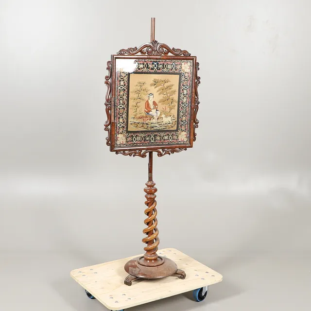A 19THC ROSEWOOD POLE SCREEN WITH A NEEDLEWORK PANEL.