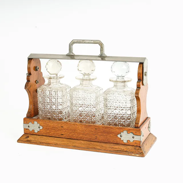 Tantalus made of oak with three decanters, first half of the 20th century