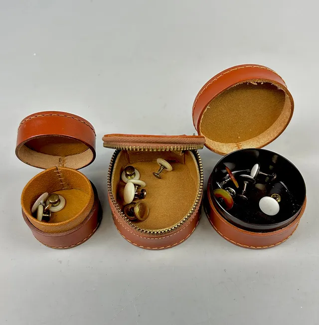 THREE VINTAGE LEATHER STUD CASES AND CONTENTS.
