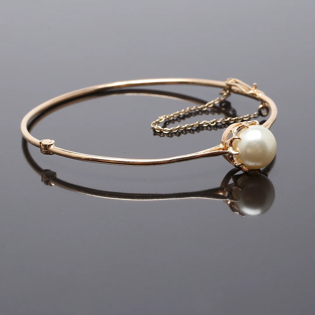 ARMBAND, 18K gult guld med odlad pärla. Stockholm 1924. — Bracelets — Garpenhus Auktioner