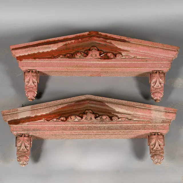 A PAIR OF CAST IRON DOOR PEDIMENTS.
