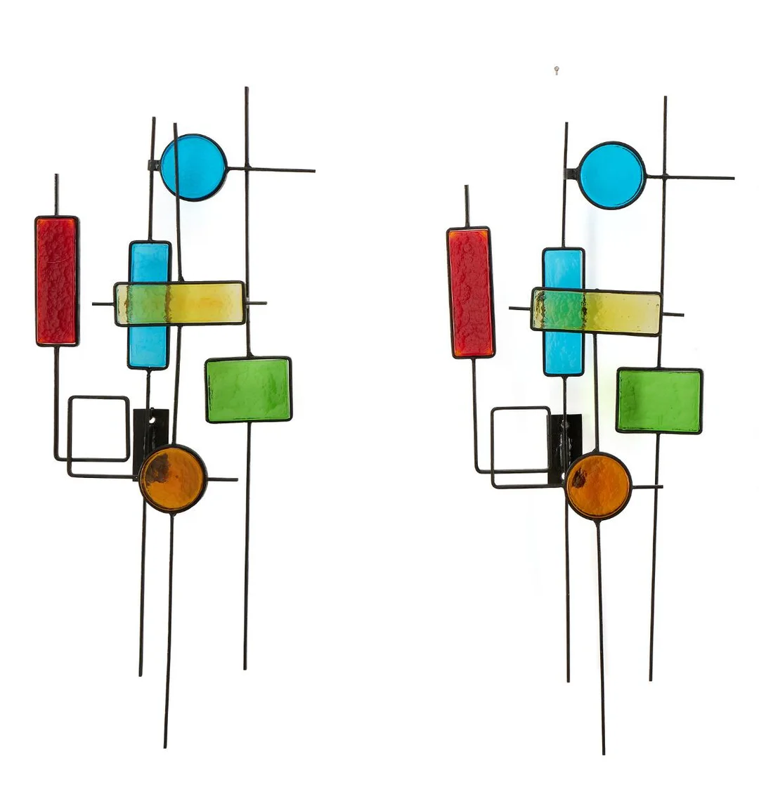 Two black painted metal wall reliefs with glass mosaics in shades of red, yellow, orange, green and turquoise. Manufactured by Holm Sørensen & Co. H. 63 cm. W. 25 cm. D. approx. 9.5 cm. (2) — Modern Decorative Art — Bruun Rasmussen