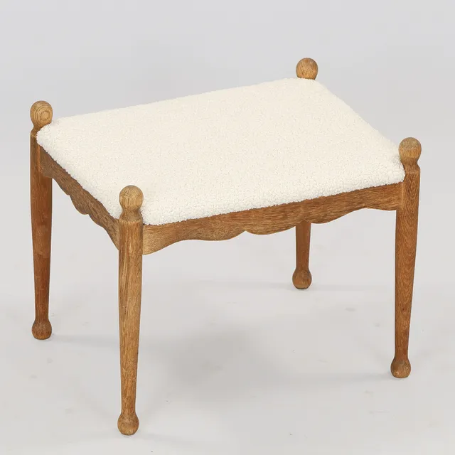 Skammel af egetræ med sæde betrukket med faux lammeskind, antageligt dansk snedkermester, Danmark, ca. 1900-tallets midte.