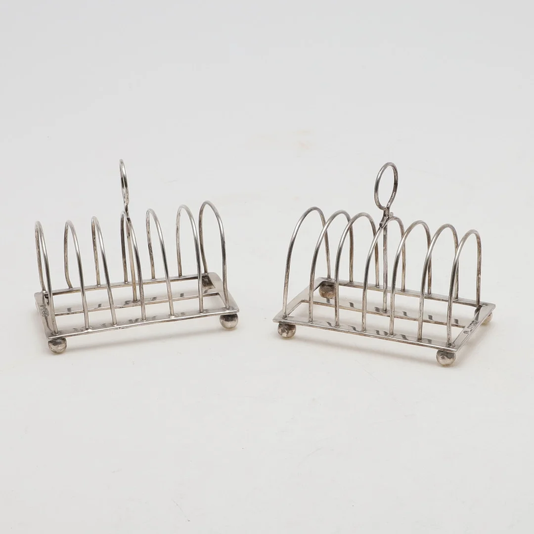 A PAIR OF EDWARDIAN TOAST RACKS. — Silver — Lawrences Auctioneers