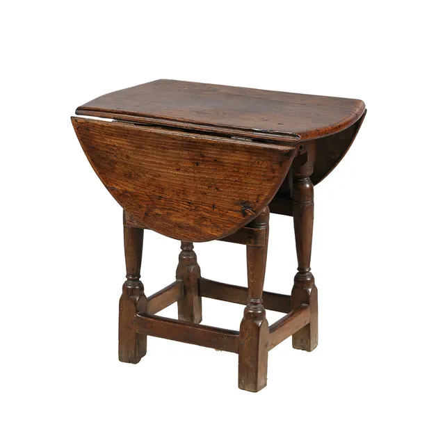 A JAMES I/CHARLES I AND LATER OAK AND ELM TABLE STOOL.