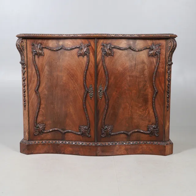 A CHIPPENDALE STYLE MAHOGANY DWARF CABINET.