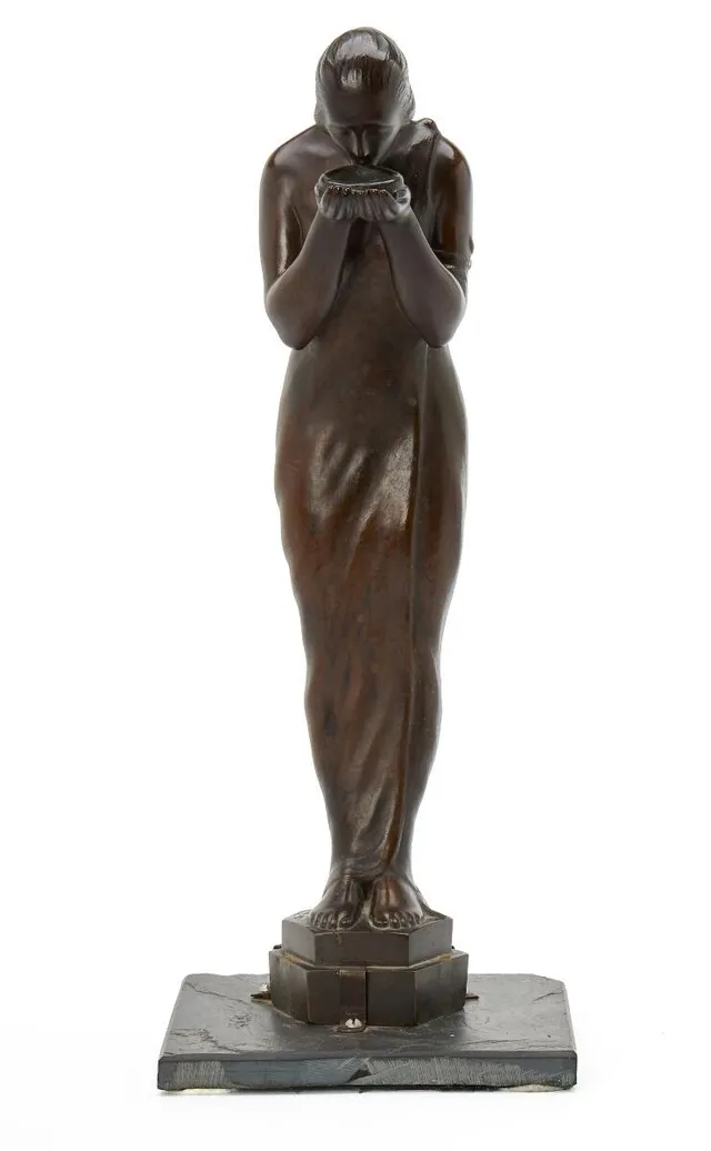 Standing Woman, 1919. Signed H. Salomon with dating. Patinated bronze mounted on slate plate. H. 46.5 cm.