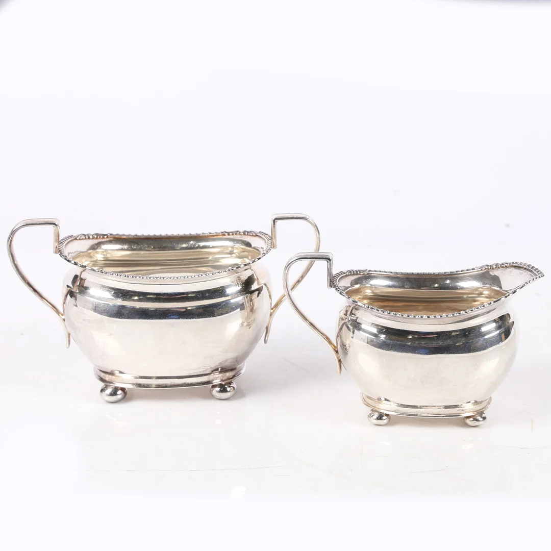 A GEORGE VI SILVER MILK JUG AND SUGAR BOWL. — Silver — Bishop & Miller