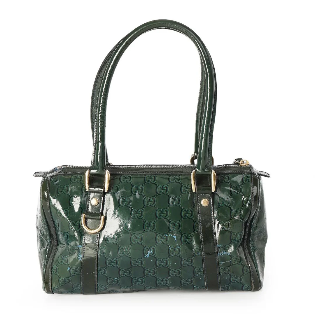 A bag of dark green monogram coated canvas with gold tone hardware, two handles, one zipped compartment with an interior zipped pocket and fabric lining. H. 18 x W. 28 x D. 12 cm. — Designer Handbags & Fashion/Designer Handbags — Bruun Rasmussen