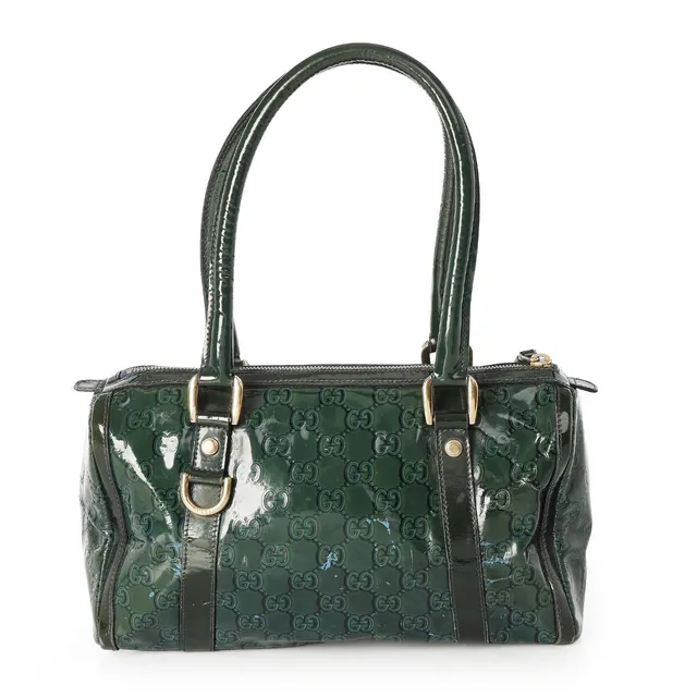 A bag of dark green monogram coated canvas with gold tone hardware, two handles, one zipped compartment with an interior zipped pocket and fabric lining. H. 18 x W. 28 x D. 12 cm.