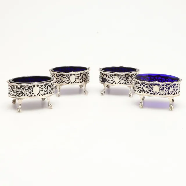 A SET OF FOUR EARLY GEORGE III SILVER SALTS.