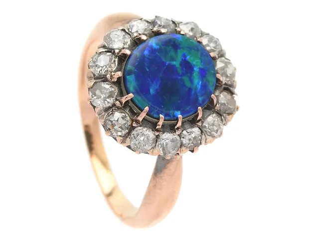 CARMOSÉRING, 18K guld, opal triplett, 14 gammalslipade diamanter ca 1,00 ctv, ca W-LB/SI-P, stl 18 mm, vikt 5,1 g, 3 diamanter skadade, 3 diamanter med nagg, opalen rör sig i fattning.